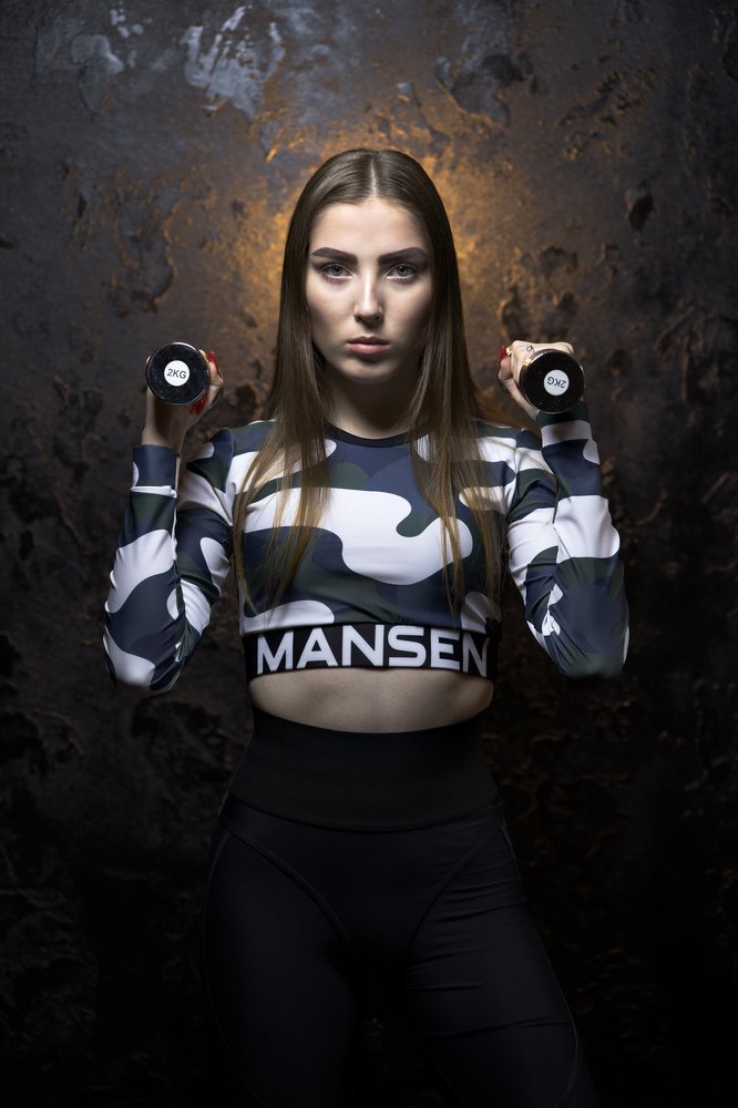 Portrait of a young woman with barbells