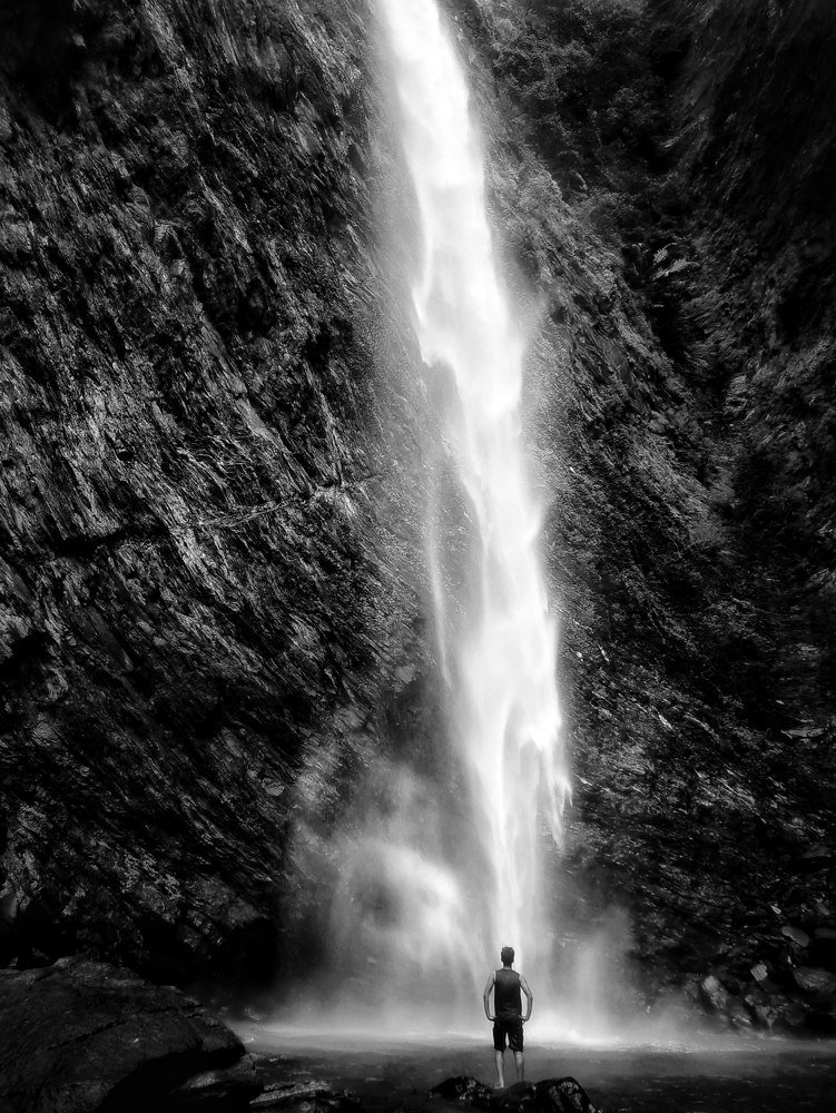 A boy by the waterfalls.