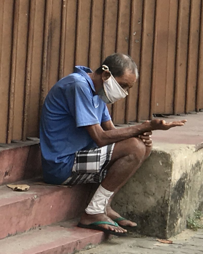 Beggar on the street with corona