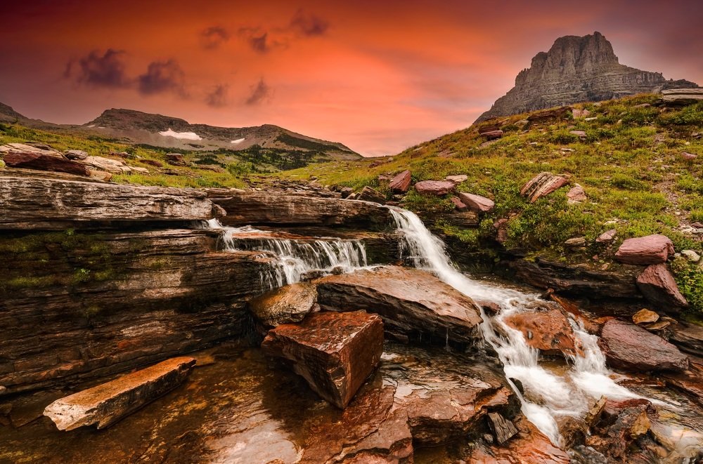 A waterfall during sunset in the mountains