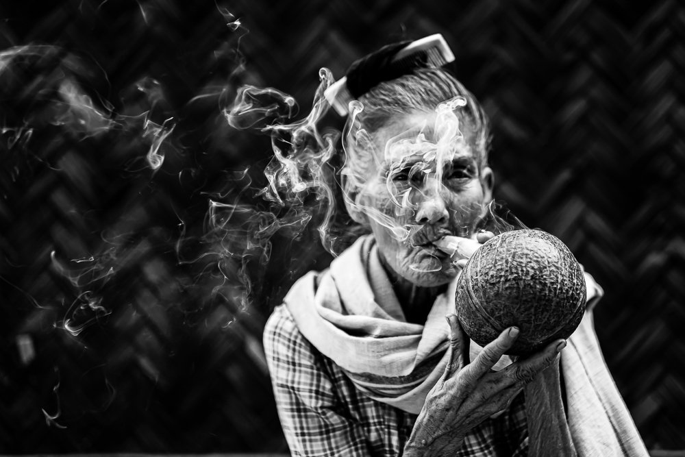 Grandmother smoking a Burmese cheroot
