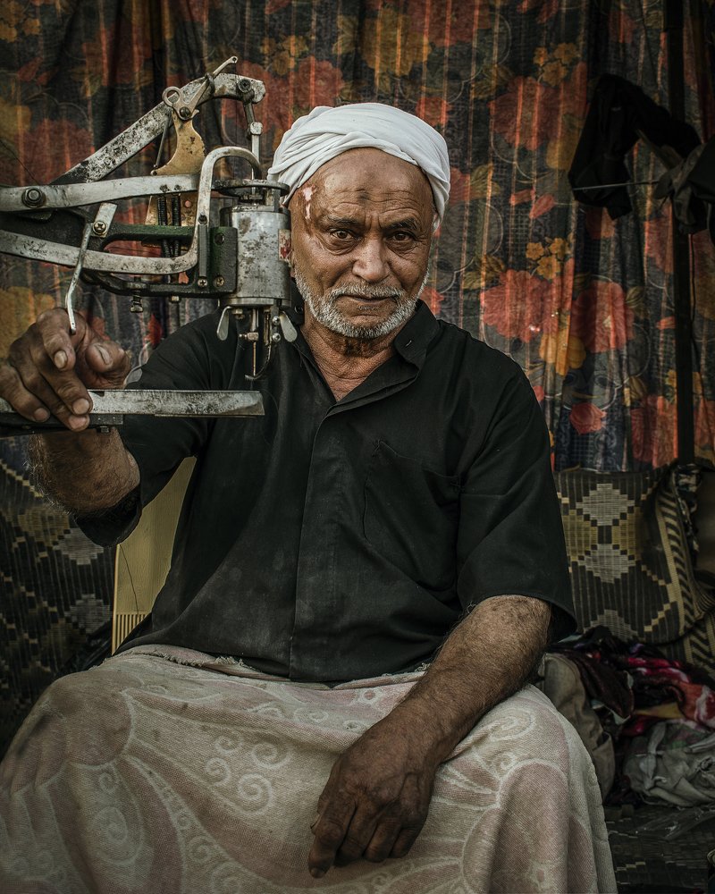 (Shoe Repairman) or what is called a cobbler in Arabic