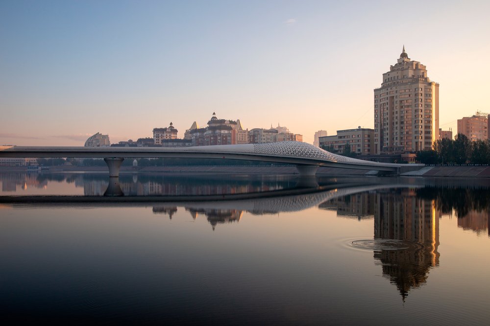 Atyrau Bridge across the Esil (Ishim) River at sunrise.