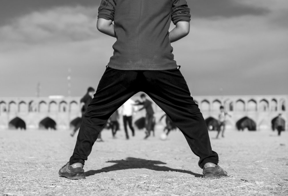 Refugees children playing football in dry riverbed!