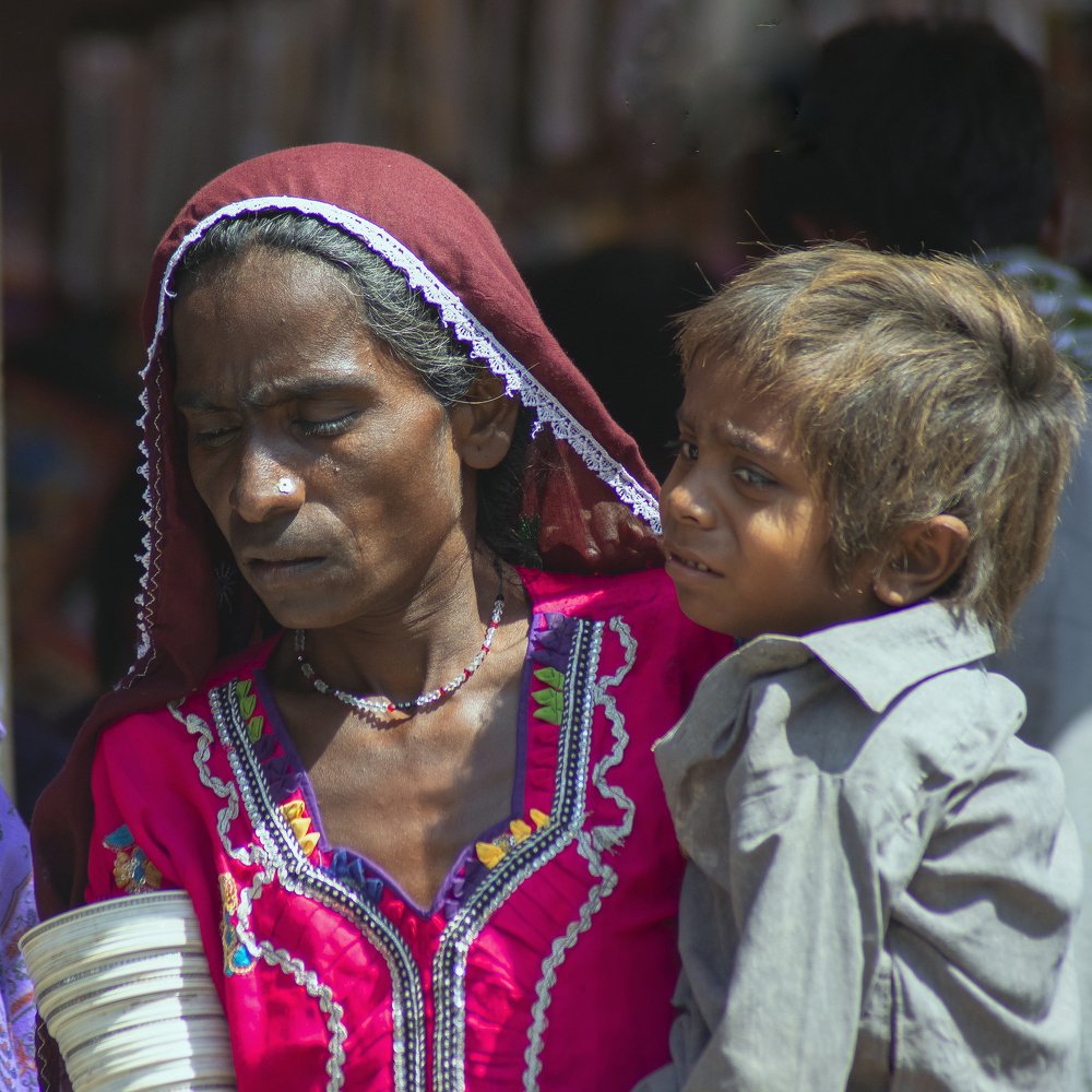 Their faces tell their whole lives,An old woman and her innocent child