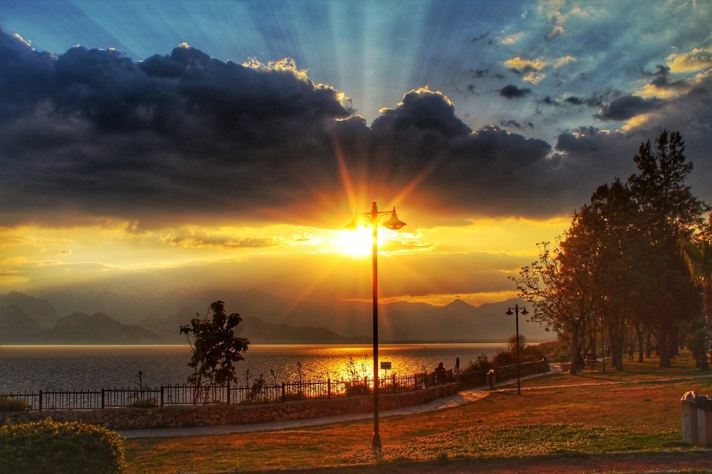 Sun's rays and street light meet in the evening..