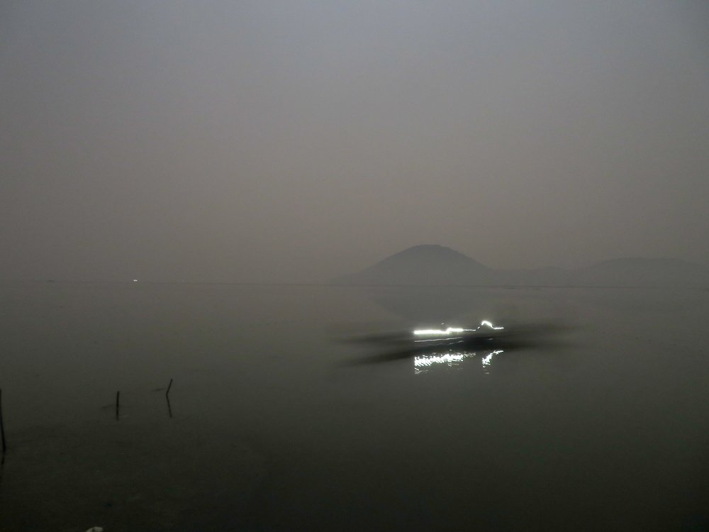 Fisher boat on full moon night