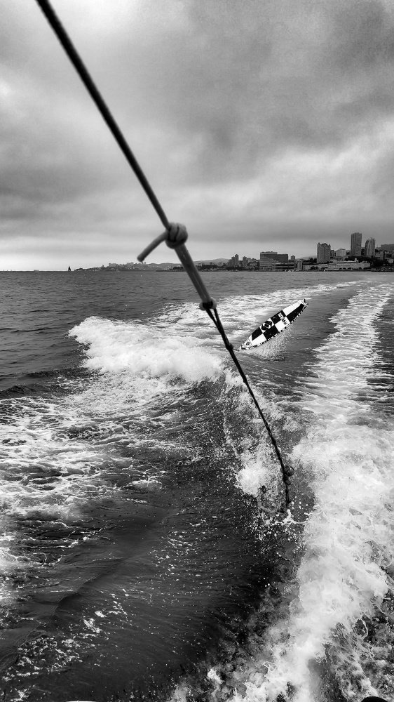 Wake surfing in rainy day