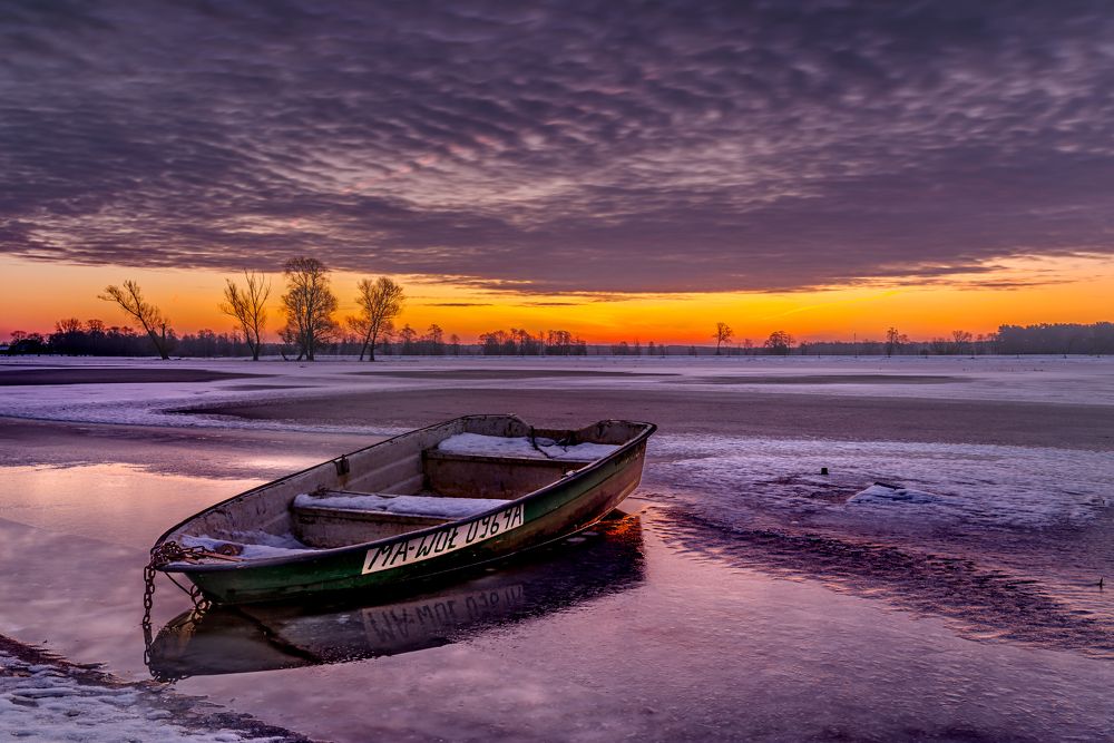 Winter sunrise, boat on Fiszor river