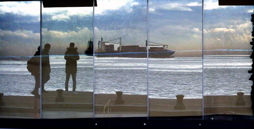 Human ghostlike silluets on seaside during covid-19 period 2020