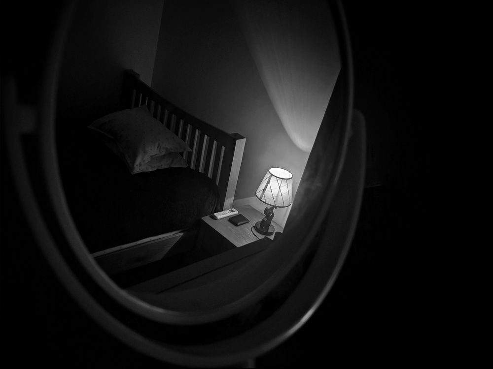 Lampshade and bed reflection