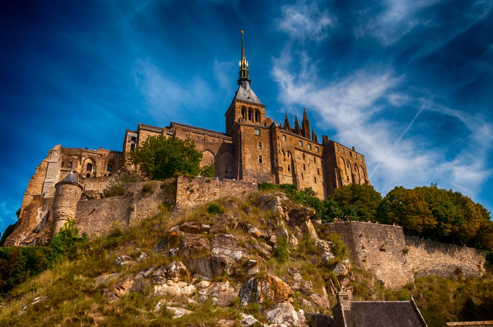 Le Mont-Saint Michel, Normandy, France on a contrast blue sky.