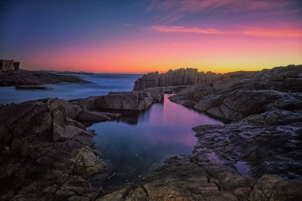 Rockpool reflections and sunrise