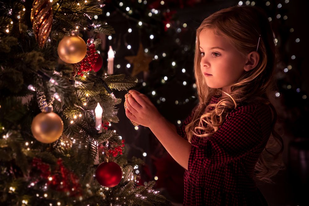 Girl decorating a Christmas tree