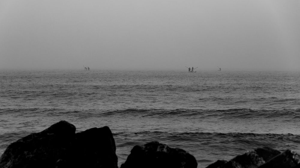 Fishermen sailing in foggy weather