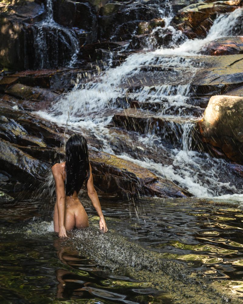 Beautiful woman in waterfall on colors