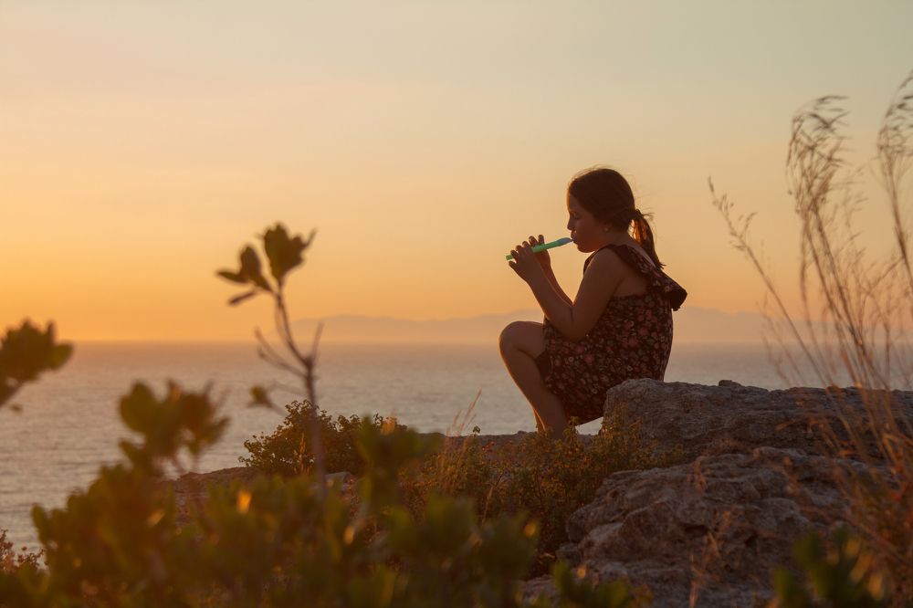 Sounds of a pipe at sunset by the sea.