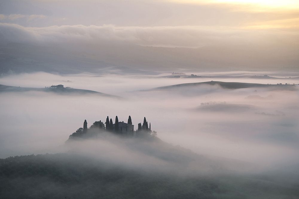 Tuscan farms suspended above the fog