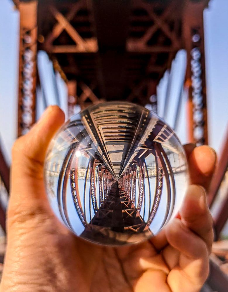 Railway bridge through a lensball