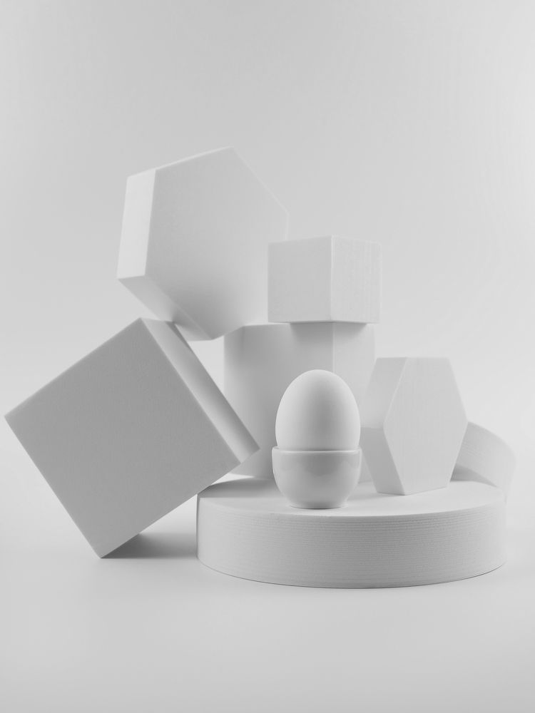 White egg on a white podium