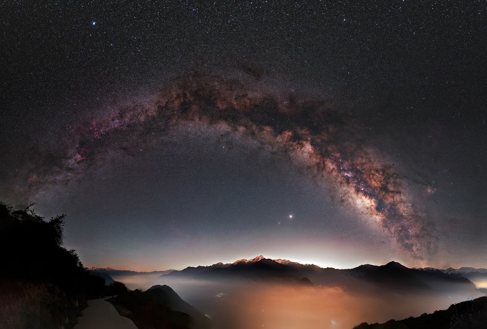 milky way above golden mountains