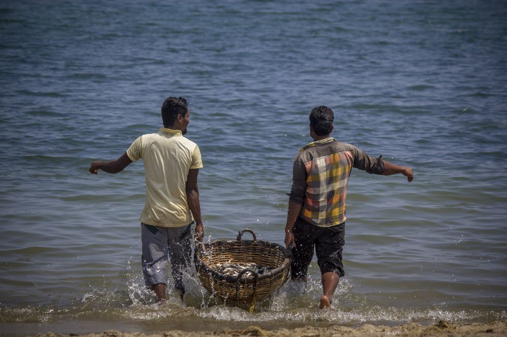 Two men with fishes