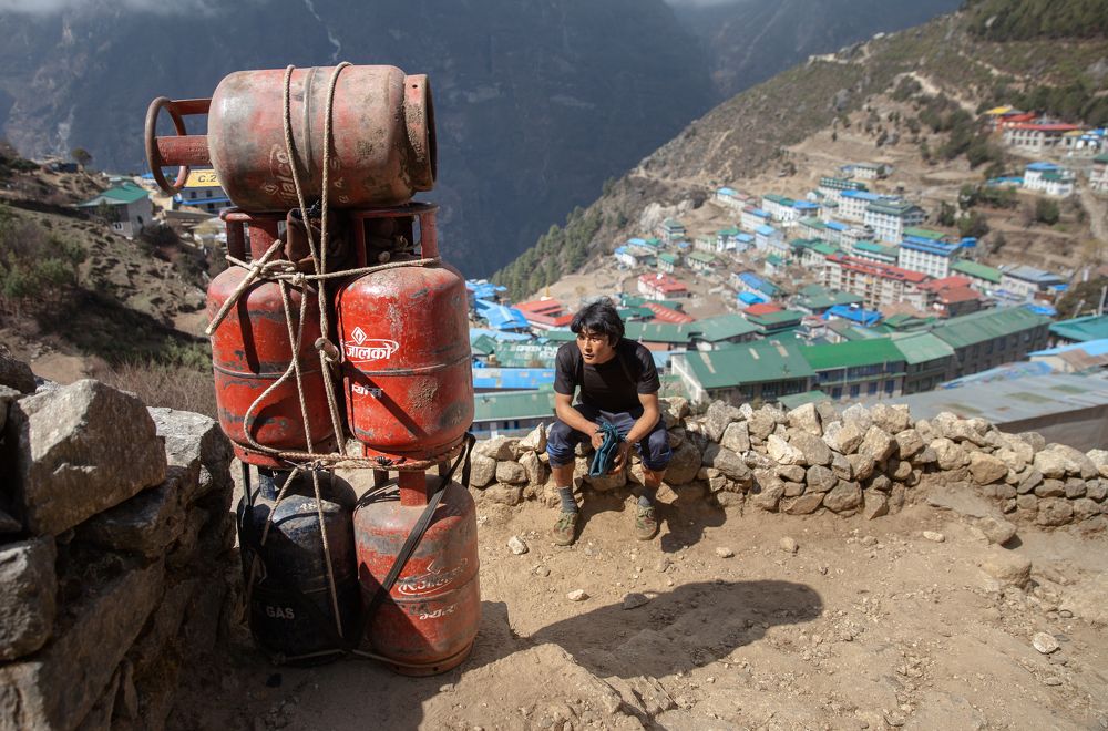 Young porter and his cargo. Weight close to 100 kg.