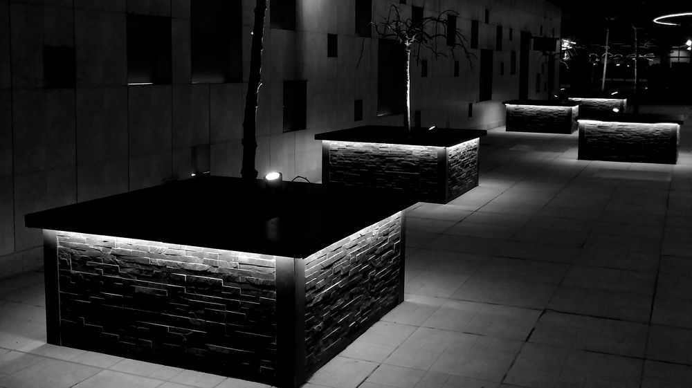 Night lights surround the hotel with seating boxes
