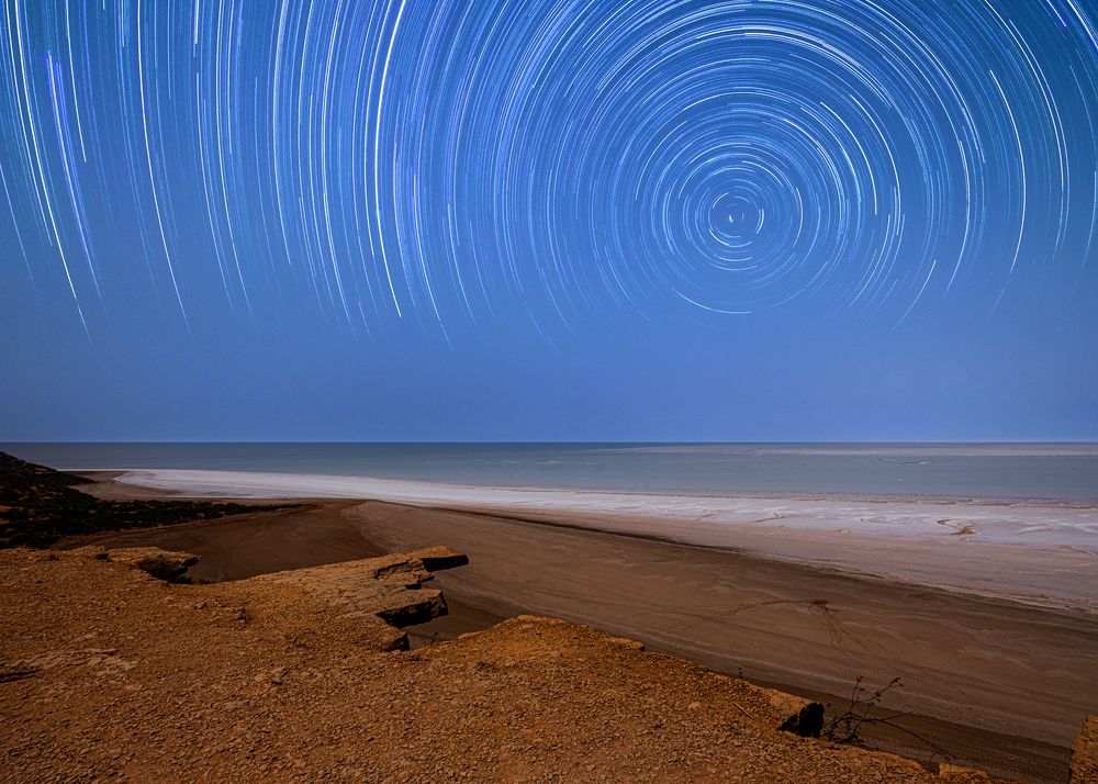 Star trails from a rocky cliff