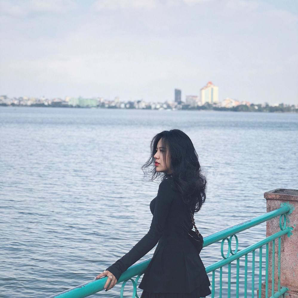 Beautiful girl standing by the lake