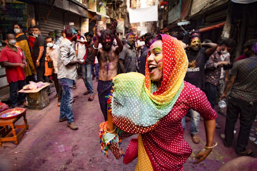 A transgender dances with joy in holi festival.