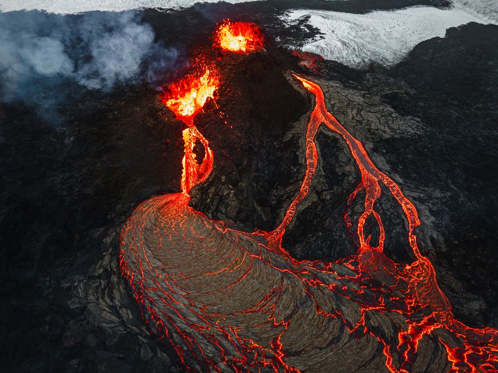 Volcanic craters erupting and creating a lava lake