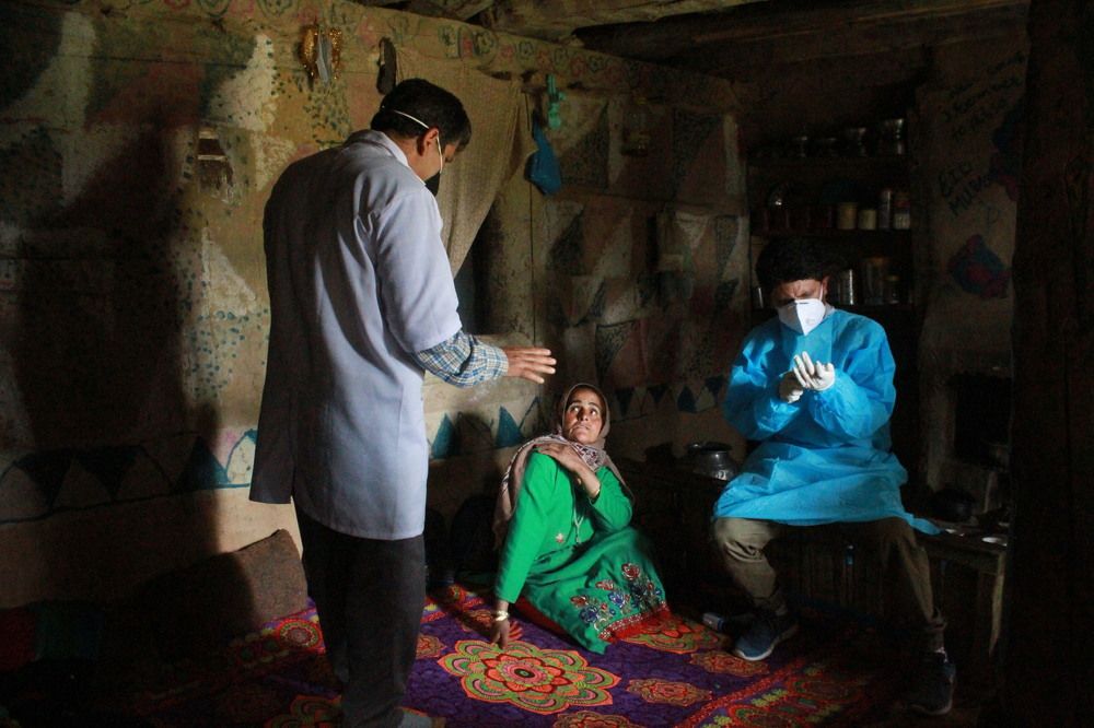 A shepherd woman receives a dose of COVISHIELD, a coronavirus disease (COVID-19) vaccine manufactured by Serum Institute of India, inside her hut during a vaccination drive at a forest area in south Kashmir's Pulwama district