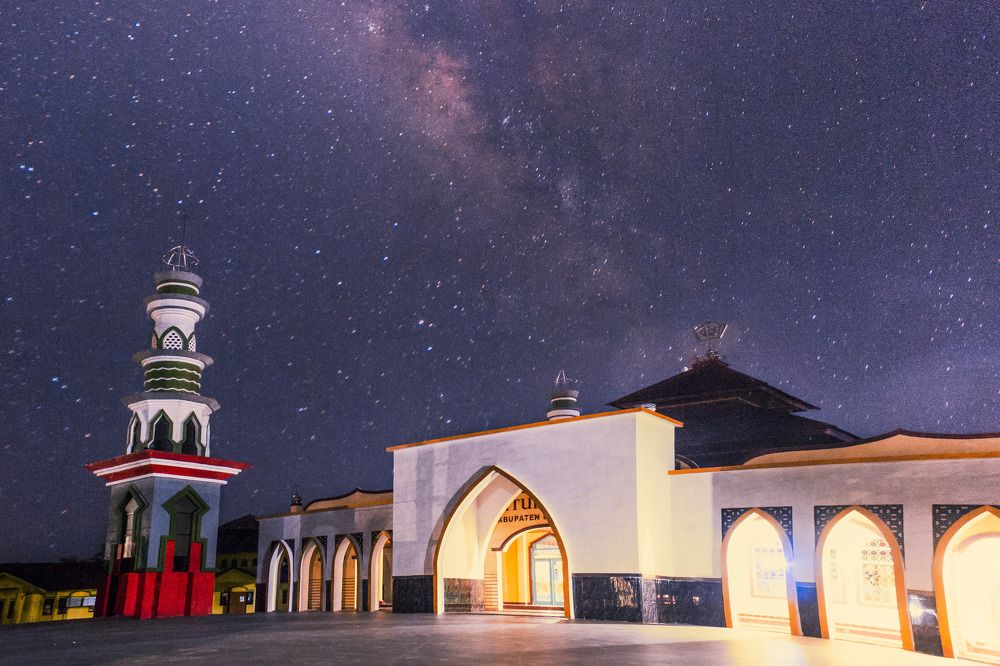night sky view with stars and milky way above the mosque