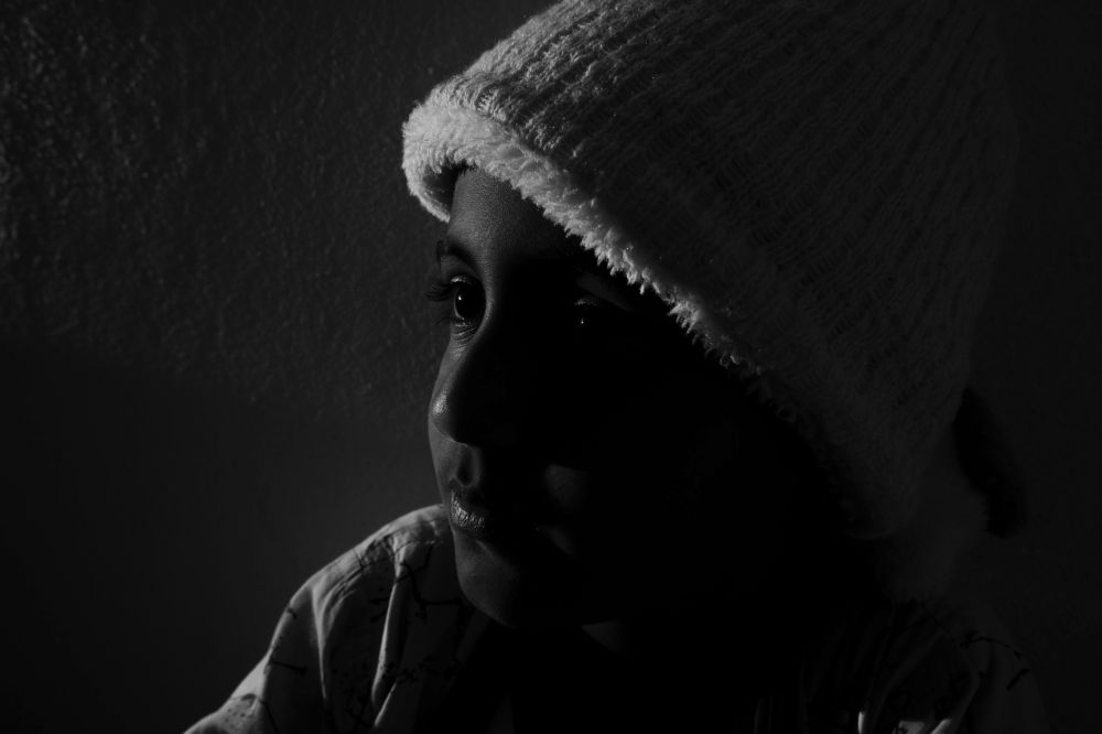 Indian boy wearing cap in cut light photography