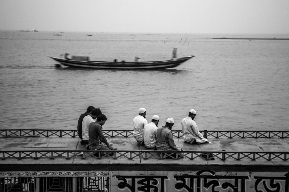 A group of Muslim praying on the boat