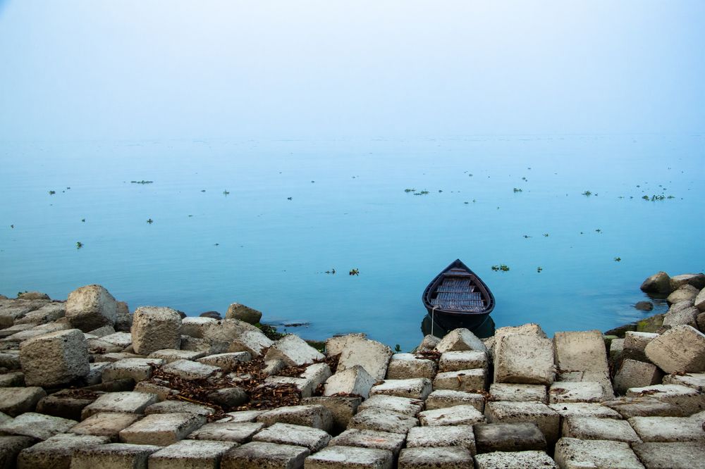 A lonely boat on the riverbank
