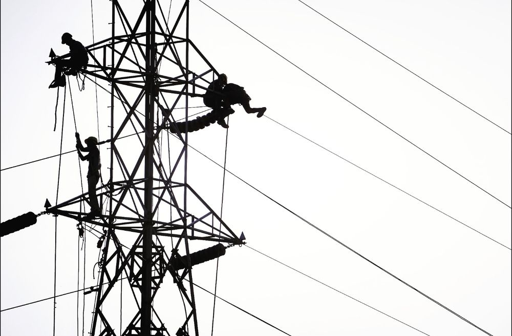 A group of electricians working on the power line