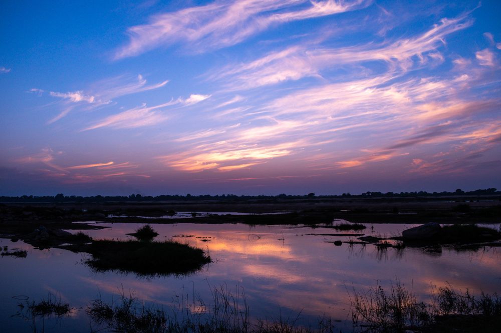 Clouds running over the river