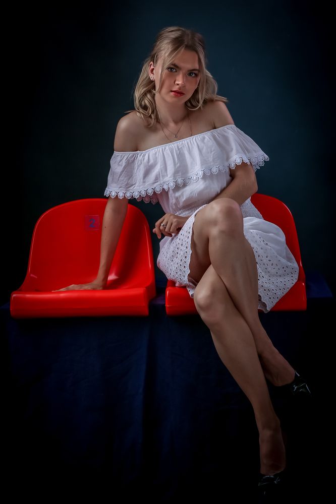 Девушка и два красных кресла