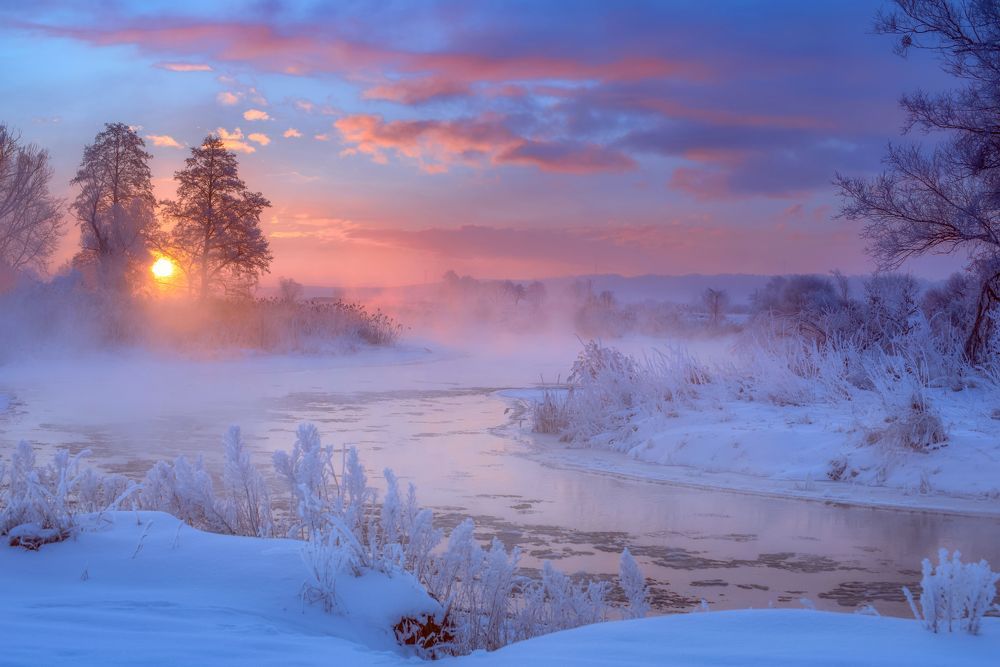 The sun rising over the misty river