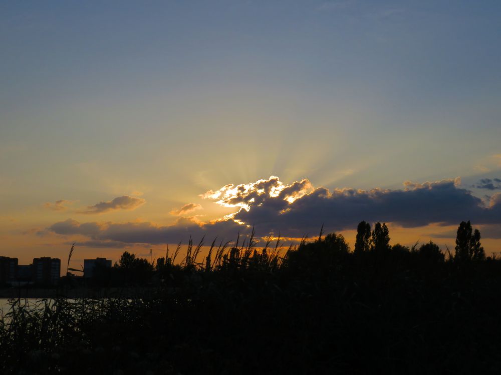 Sun rays through the clouds at sunset
