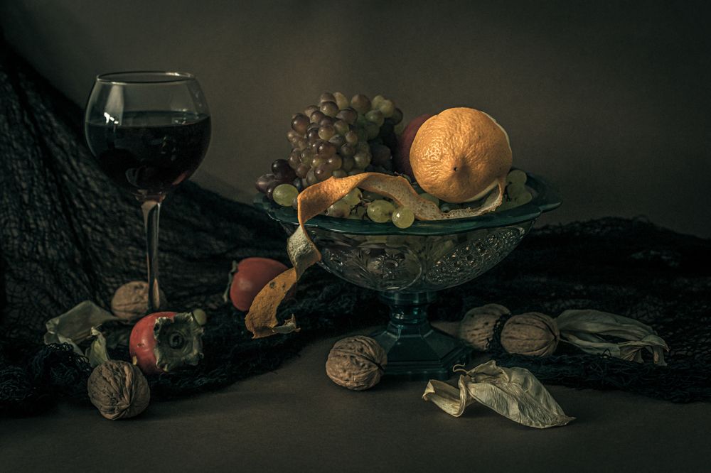 Still life with grapes, lemon and persimmon