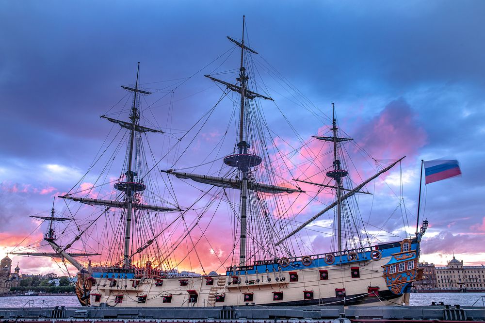 A sailboat flaming with the sunset