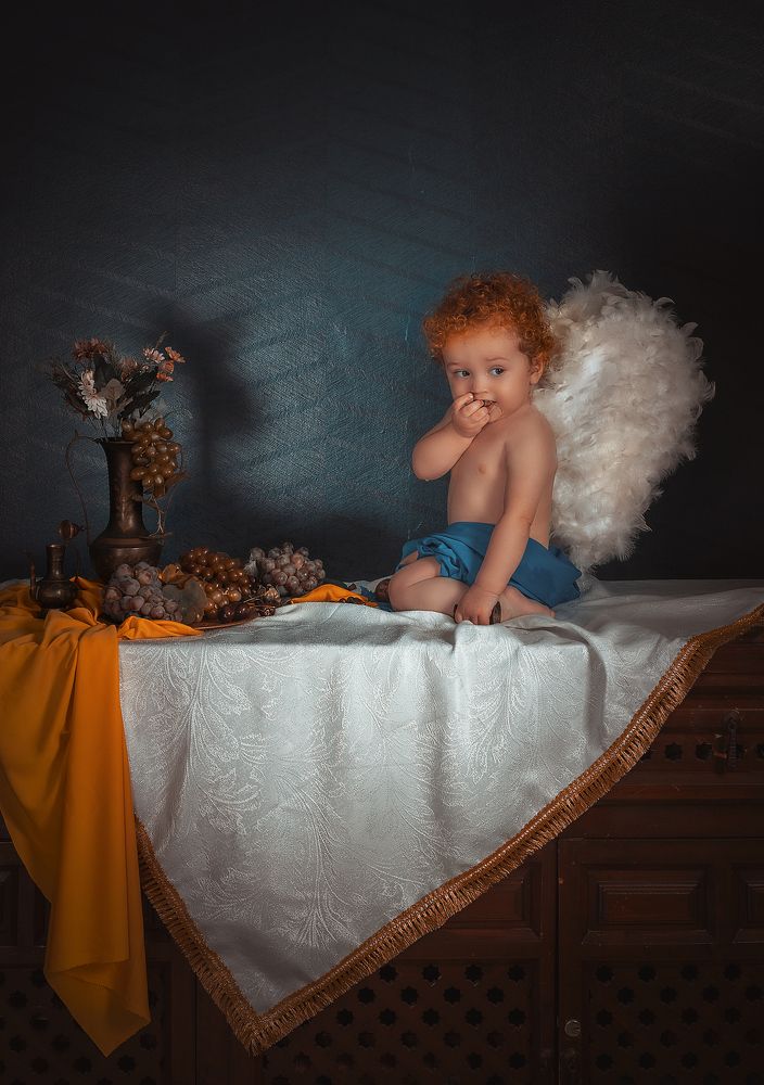 Cupidon eats grapes at still life Holland style