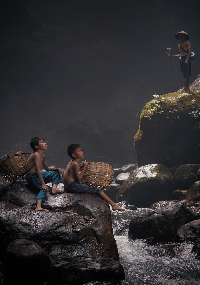 A father and his two kids out river fishing