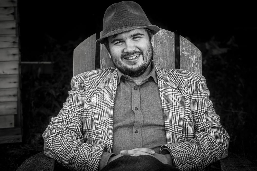 A man in a wooden chair