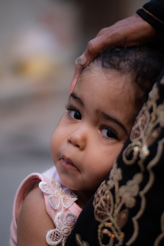 A little girl in her grandmother's lap