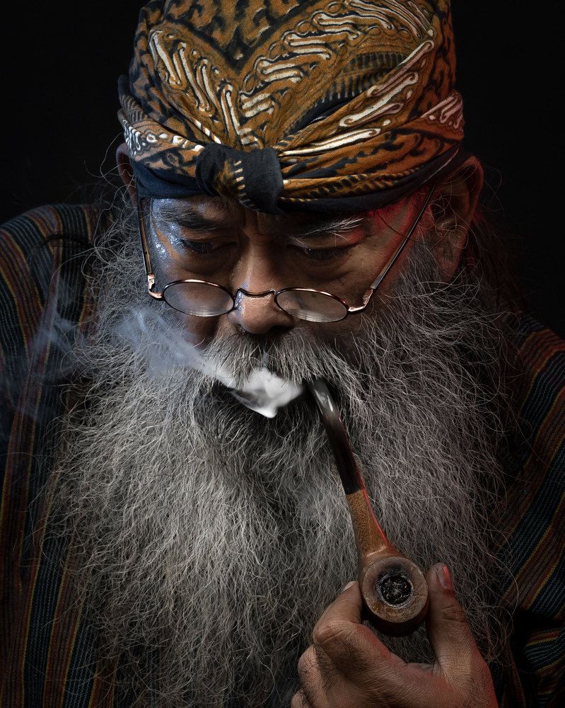 Old man smoking a pipe.