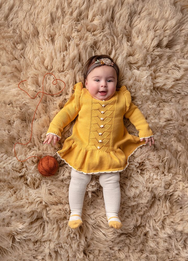 Baby with yellow dress.